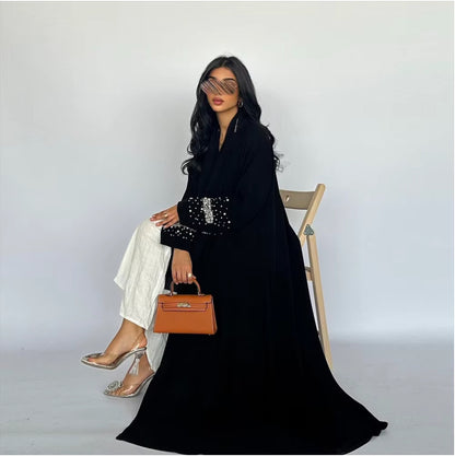 Woman sitting in chair wearing a luxury abaya – modest and relaxed outfit